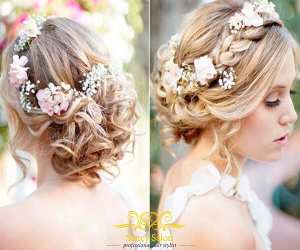 Tóc uốn xoăn sóng tết nhẹ đính hoa giúp các cô dâu thêm phần rực rỡ, xinh đẹp.